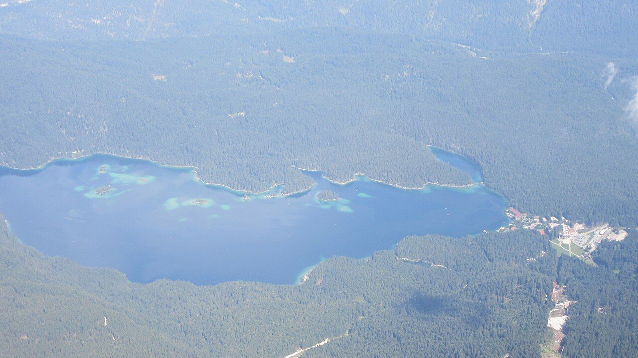 Pohled z vrcholu Zugspitze dolů na tyrkysové jezero Eibsee